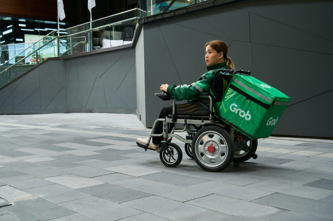 Worker delivering food in a wheelchair