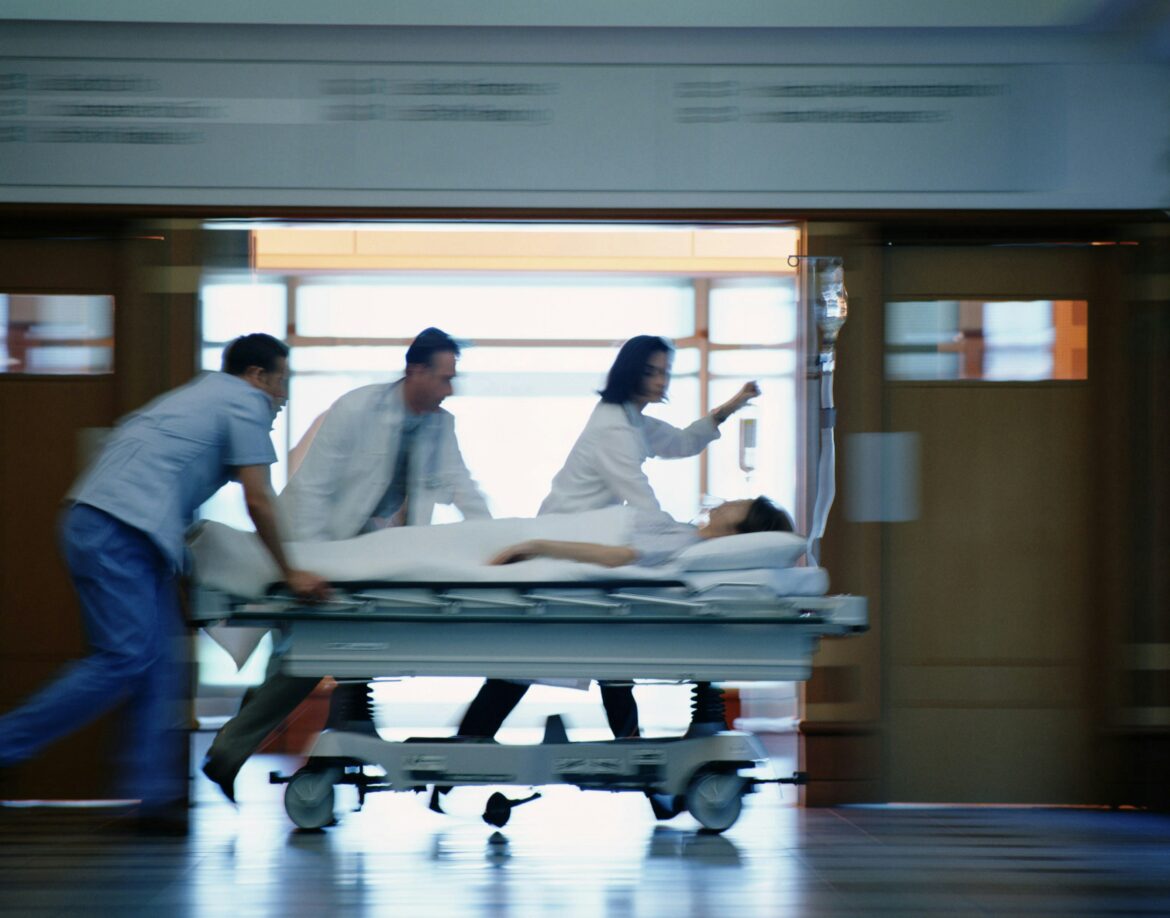 Doctors rush patient in hospital
