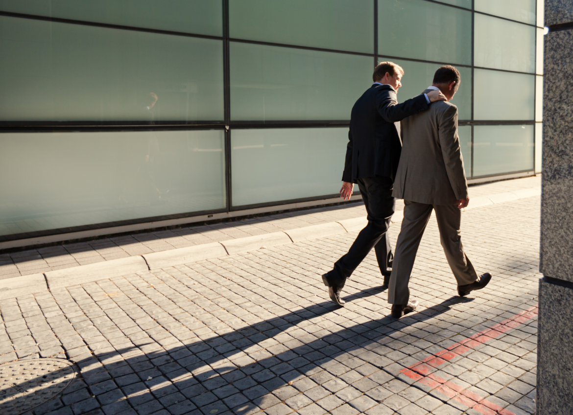 Businessmen walking on city street