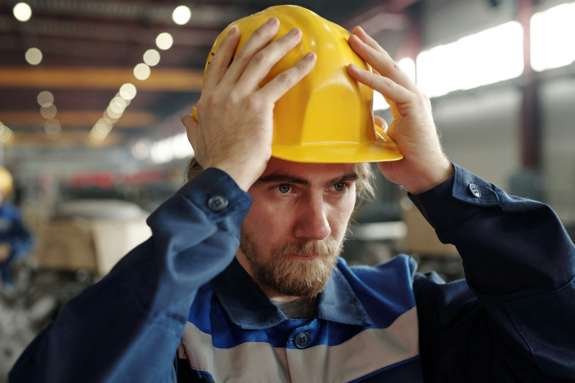 Worker putting on a hard hat
